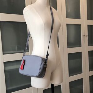 Stylish Gray and Red Crossbody Bag with Adjustable Strap